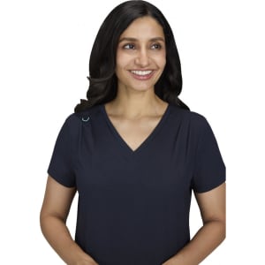 A navy Sari Top featuring a V-neck design, displayed by a smiling woman with long hair. The top has a logo on it.