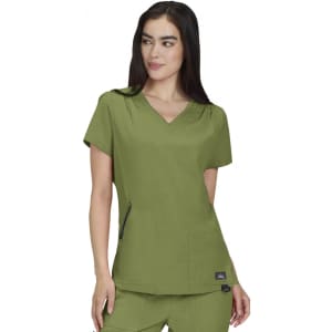 A short-sleeved, olive green medical scrub top with a V-neck and two front pockets. The top features a logo.