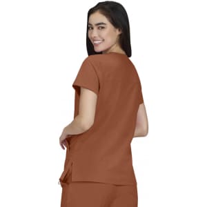 A woman is wearing a brown Sari Top, shown from the back, with a relaxed fit and short sleeves.
