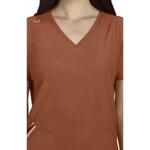 A Sari Top in rust colour features a V-neck design and short sleeves, with a pocket and small embellishment.
