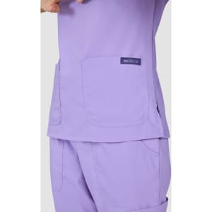 A top in a soft lavender colour with two large pockets and a logo tag.