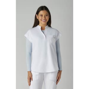 A white top with a relaxed fit and short sleeves, featuring a pocket and a logo.