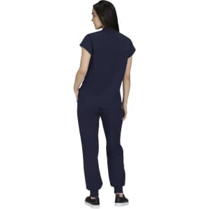 A woman wearing a navy blue top and matching pants, viewed from the back. The outfit features a soft fabric and modern design.