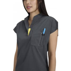 A grey top with short sleeves featuring a pocket and a yellow zipper detail, worn by a model.