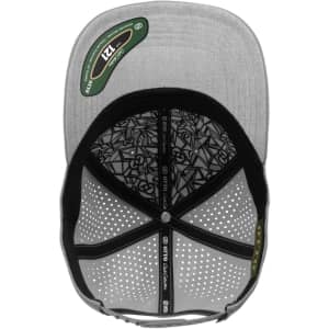 A grey six-panel cap with a perforated design and an interior featuring a patterned lining. It has a logo on the inside.