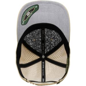 A perforated cap featuring a grey top and tan brim, with an inner patterned lining and a logo inside.