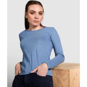 A blue long-sleeved women's t-shirt displayed on a model, featuring a simple design and a logo.