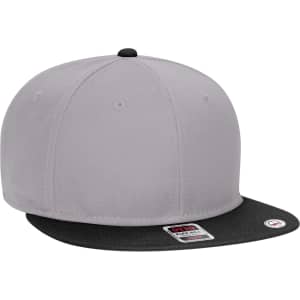 A mid-profile snapback cap in grey with a black peak, featuring a logo on the side. Suitable for youth.