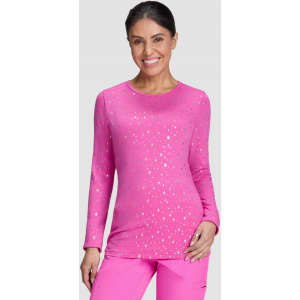 A long-sleeve pink tee with a speckled design, paired with matching pink bottoms. The model has a friendly smile.