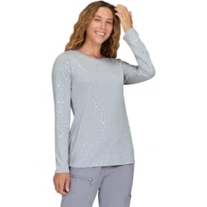 A long-sleeve grey shirt with a dotted pattern, featuring a woman smiling and running her hand through her hair.