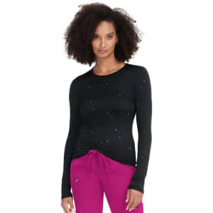 A black long-sleeve tee with a dotted pattern, worn by a model. The model pairs it with pink pants.
