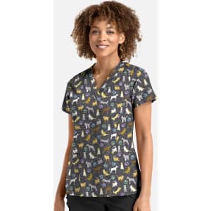 A V-neck top featuring a colourful pattern of various dog breeds on a dark background. The top has a logo.