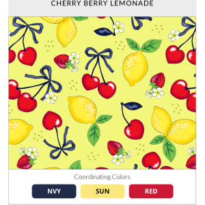 A vibrant yellow fabric with a cherry and lemon pattern, featuring strawberries and floral accents.