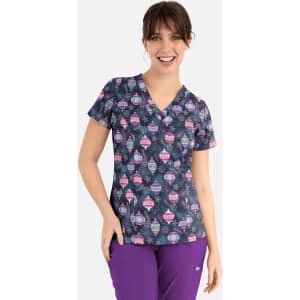 A woman wearing a navy V-neck top with a colourful print of various whimsical designs and a logo.