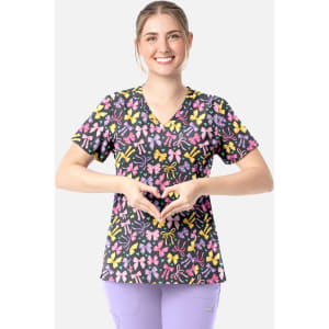A woman wears a multicoloured V-neck top with a floral print, featuring a variety of shapes and colours.