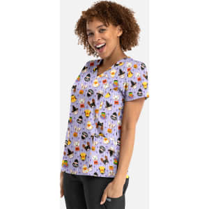 A women's v-neck top in purple featuring a playful print of various Halloween-themed designs, with a logo on the side.