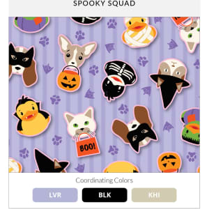 A patterned fabric featuring cute Halloween-themed animals like cats, dogs, and ducks on a purple background.