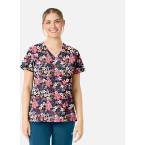 A floral V-neck top featuring a mix of pink, white, and navy flowers against a dark background, worn by a smiling model.