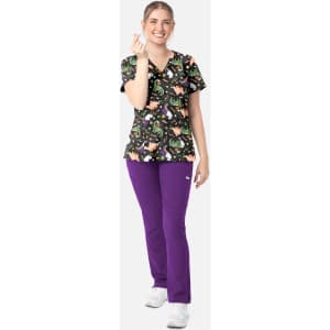 A women’s V-neck print top featuring a colourful pattern, paired with purple pants and white shoes. Includes branding.