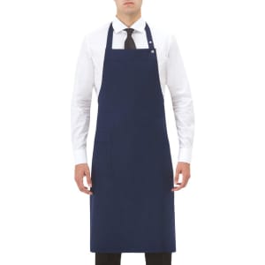 A navy blue apron worn by a model, featuring a front pocket and an adjustable neck strap, with a logo present.