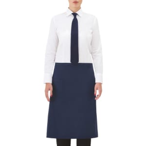 A navy apron worn over a white shirt and tie, featuring a front pocket and a simple design.