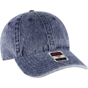 A denim blue 6-panel low profile dad cap with a branded logo on the front.