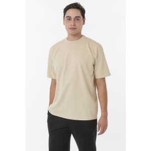 A short sleeve crewneck tee in beige, featuring a relaxed fit and a simple design, shown on a model.