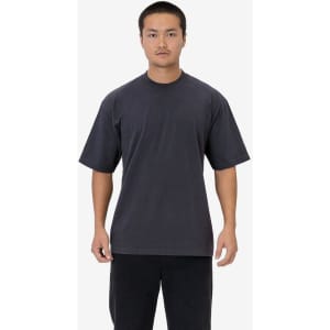 A dark grey short sleeve garment-dyed crewneck tee displayed on a model, featuring a casual fit.