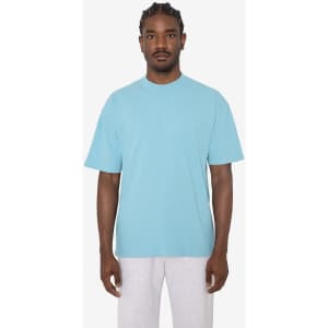 A light blue short sleeve crewneck tee displayed on a model, featuring a relaxed fit and a logo.