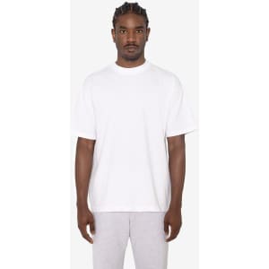 A white short sleeve crewneck tee, featuring a relaxed fit and a logo on the front. The model wears grey shorts.