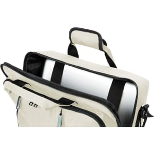 A cream laptop backpack with a black interior, featuring a top handle and a compartment for a laptop.