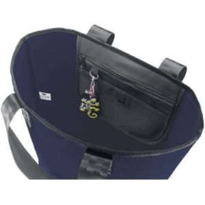 A reusable grocery bag in navy blue with a zippered pocket and a keychain inside. Features sturdy handles and has a logo.
