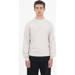 A long sleeve crewneck tee in a light grey colour, featuring a relaxed fit and a simple logo.