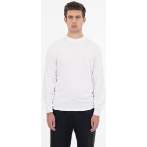 A long sleeve crewneck tee in white, featuring a minimalistic design and a fitted silhouette.
