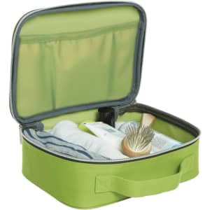 A green Switch Zipper Bag opened to reveal personal care items neatly organised inside. It features a logo.