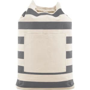 A striped beach backpack in cream and navy, featuring a front pocket and a rope handle. It has a logo on it.