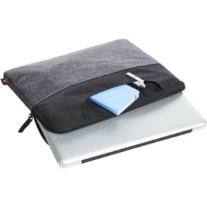 A grey and black laptop bag with a notebook and pen visible on top, designed for carrying laptops.