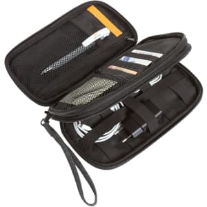 A black frame organiser featuring compartments for cables, pens, cards, and a spacious main section. It includes a branding logo.