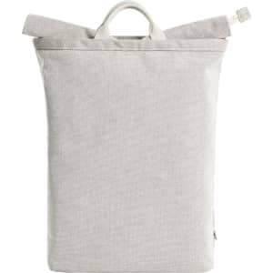 A grey Loom Backpack with a minimalist design and a top handle. It features a logo on the front.