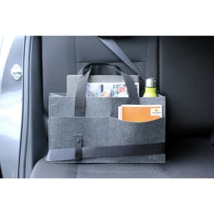 A grey organiser bag with handles, featuring pockets for documents and a drink bottle, sits on a vehicle seat.