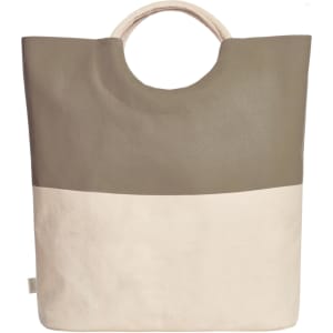 A tote bag featuring a green upper section and a cream lower section, with a rounded handle and a logo present.