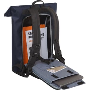 A navy Kurier Notebook Backpack with adjustable straps, featuring an open compartment displaying a laptop and documents.
