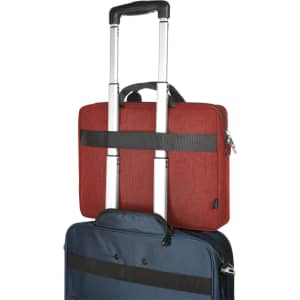 A red laptop bag with a handle and straps mounted on a blue wheeled suitcase. Both bags feature zippers and metal handles.