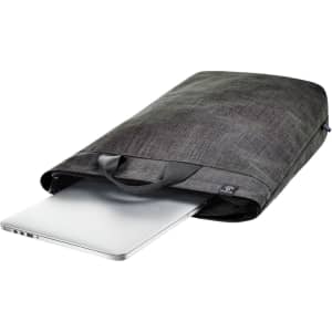 A grey laptop backpack with a sleek design, featuring a handle and a partially visible laptop at the opening.