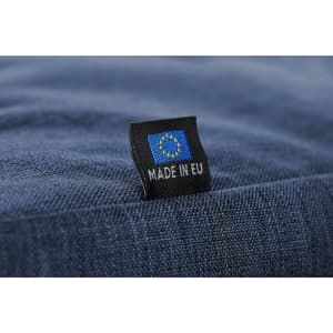 A blue fabric duffle bag featuring a tag that indicates it is made in the EU.