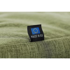 A green fabric surface with a tag featuring a logo and text indicating "MADE IN EU."