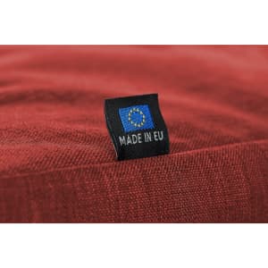 A red fabric with a small label featuring a European flag and the text "MADE IN EU."