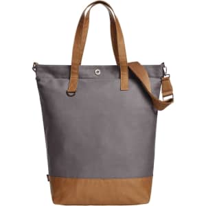 A grey tote bag with tan straps and a bottom panel, featuring a logo on the side.