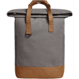 A grey backpack with a fold-over top and tan leather accents. It features dual straps and a side pocket.