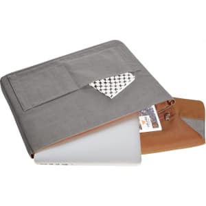 A grey laptop bag with a patterned pocket, partially open with a laptop inside and a brown interior. It has a logo.